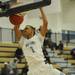 Skyline's Theron Wilson hangs from the rim after dunking the ball during the second half against Chelsea at Skyline on Tuesday night.  Melanie Maxwell I AnnArbor.com